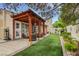 Backyard area with covered patio, low-maintenance turf, and landscaped borders at 7608 Vista Hills Dr, Las Vegas, NV 89128