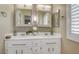Bathroom boasts double sinks with decorative mirrors and attractive fixtures at 7608 Vista Hills Dr, Las Vegas, NV 89128