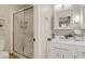 Well-lit bathroom features glass door shower, designer mirror and modern fixtures at 7608 Vista Hills Dr, Las Vegas, NV 89128