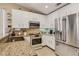 Stylish kitchen with granite countertops, stainless steel appliances and modern fixtures at 7608 Vista Hills Dr, Las Vegas, NV 89128