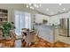 Bright eat-in kitchen features white cabinets, a stone accent wall, and stainless steel appliances at 7608 Vista Hills Dr, Las Vegas, NV 89128