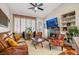 Cozy living room featuring a stone fireplace, vaulted ceiling, and comfortable seating at 7608 Vista Hills Dr, Las Vegas, NV 89128