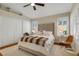 Cozy main bedroom with large bed, shuttered windows, and neutral decor at 7608 Vista Hills Dr, Las Vegas, NV 89128