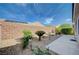 Private backyard featuring desert landscaping, stone, plants, and covered patio at 7732 Songster St, North Las Vegas, NV 89084