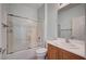 This bathroom features a shower-tub combination and a vanity with a sink and mirror at 7732 Songster St, North Las Vegas, NV 89084