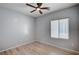 This is a simple bedroom with wood-look flooring, neutral walls and a ceiling fan at 7732 Songster St, North Las Vegas, NV 89084