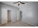 This bedroom has closet and bathroom access plus wood-look floors and a ceiling fan at 7732 Songster St, North Las Vegas, NV 89084