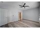 A bright bedroom with laminate flooring and a ceiling fan at 7732 Songster St, North Las Vegas, NV 89084