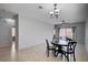Open concept dining area with neutral colors, tiled floor, and sliding doors to backyard at 7732 Songster St, North Las Vegas, NV 89084