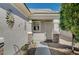 Inviting front entrance with decorative details, stone accents, and a charming sunburst wall decor at 7732 Songster St, North Las Vegas, NV 89084