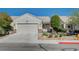 Charming single-story home featuring a well-manicured front yard and two-car garage at 7732 Songster St, North Las Vegas, NV 89084