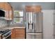Modern kitchen view of stainless steel refrigerator and window at 7732 Songster St, North Las Vegas, NV 89084