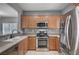 Well-lit kitchen featuring stainless steel appliances and wooden cabinetry at 7732 Songster St, North Las Vegas, NV 89084