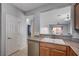 Kitchen sink and granite countertop with view to living areas at 7732 Songster St, North Las Vegas, NV 89084