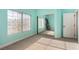 A bedroom with blue walls, large windows and mirrored closet doors that reflect the light at 7900 Riviera Beach Dr, Las Vegas, NV 89128