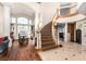 Grand foyer with a sweeping staircase, elegant chandelier, and beautiful hardwood floors at 7900 Riviera Beach Dr, Las Vegas, NV 89128