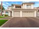 Traditional two-story home with a two-car garage, manicured lawn, and mature landscaping at 7900 Riviera Beach Dr, Las Vegas, NV 89128