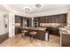 Modern kitchen featuring dark cabinetry, granite countertops, and an island with seating at 7900 Riviera Beach Dr, Las Vegas, NV 89128