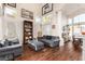 Spacious living room with wood floors, high ceilings, tall windows, and comfortable seating area at 7900 Riviera Beach Dr, Las Vegas, NV 89128