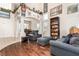 Spacious living room with tall ceilings, wood floors, abundant natural light, and comfortable seating at 7900 Riviera Beach Dr, Las Vegas, NV 89128