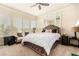 Bright primary bedroom featuring a large bed, mirrored wall, and abundant natural light at 7900 Riviera Beach Dr, Las Vegas, NV 89128