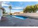 A relaxing backyard pool features clear blue water, a stone tile trim, and is surrounded by mature trees at 7900 Riviera Beach Dr, Las Vegas, NV 89128