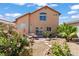 Desert landscaped backyard featuring native plants, patio, and house at 7954 Kentshire Dr, Las Vegas, NV 89117