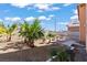 Desert landscaped backyard featuring native plants, hardscape, and sitting area at 7954 Kentshire Dr, Las Vegas, NV 89117