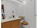Well-lit bathroom featuring a wooden toilet seat, a large mirror, and ample counter space at 7954 Kentshire Dr, Las Vegas, NV 89117