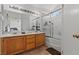 Well-lit bathroom featuring double sinks and a shower-over-tub combination at 7954 Kentshire Dr, Las Vegas, NV 89117