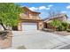 Charming two-story home featuring a desert landscape and a two-car garage, ideal for curb appeal at 7954 Kentshire Dr, Las Vegas, NV 89117
