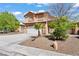 Charming two-story home featuring a desert landscape, a two-car garage, and a tile roof, ideal for curb appeal at 7954 Kentshire Dr, Las Vegas, NV 89117