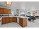 Spacious open kitchen boasts white tile floors, a breakfast bar, and modern appliances at 7954 Kentshire Dr, Las Vegas, NV 89117