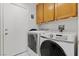 Functional laundry area with modern washer and dryer units and ample storage space at 7954 Kentshire Dr, Las Vegas, NV 89117