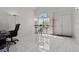 Bright living room with white tile flooring, modern furnishings, and bright entryway at 7954 Kentshire Dr, Las Vegas, NV 89117