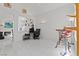 Bright living room with white tile flooring, adjacent office space, and modern furnishings at 7954 Kentshire Dr, Las Vegas, NV 89117