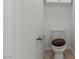 Compact half-bath features toilet, wall-mounted soap dish, and tiled flooring at 7954 Kentshire Dr, Las Vegas, NV 89117
