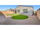This backyard features artificial turf, brick pavers, and easy-to-care landscaping at 80 Brixton Ave, Henderson, NV 89011