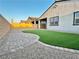 Serene backyard offers easy maintenance with artificial turf, rock beds, and brick pavers at 80 Brixton Ave, Henderson, NV 89011