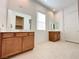 Elegant bathroom with dual vanities, neutral tile flooring, and ample counter space at 80 Brixton Ave, Henderson, NV 89011