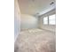 Light-filled bedroom with neutral carpeting and bright white walls at 80 Brixton Ave, Henderson, NV 89011