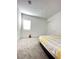 Cozy bedroom featuring soft carpeting, a bright window, and a convenient closet for storage at 80 Brixton Ave, Henderson, NV 89011
