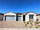 Charming single-story home with a well-maintained front yard and a three-car garage at 80 Brixton Ave, Henderson, NV 89011