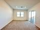 Bright living room with sliding glass doors and plush carpeting at 80 Brixton Ave, Henderson, NV 89011