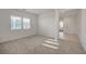 Sun-filled living room with neutral carpeting and bright white walls at 80 Brixton Ave, Henderson, NV 89011