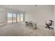 Spacious living room featuring large sliding glass doors and neutral carpeting at 80 Brixton Ave, Henderson, NV 89011