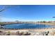 Community pond offers a scenic view with walking paths, landscaping, and mountain views at 80 Brixton Ave, Henderson, NV 89011
