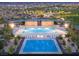 Aerial view of a large community pool area with a recreational splash pad and ample seating for residents at 80 Brixton Ave, Henderson, NV 89011