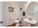 Cozy half bathroom features a modern sink, neutral paint, and tiled floors at 8084 Celina Hills St, Las Vegas, NV 89131
