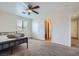 Comfortable secondary bedroom featuring neutral colors, plush carpeting, and a ceiling fan at 8084 Celina Hills St, Las Vegas, NV 89131